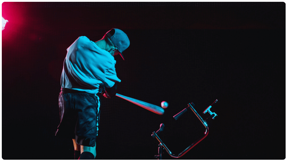 Young baseball player practicing swing with the best batting tee for young baseball players, perfecting stance and contact under stadium-style lighting.