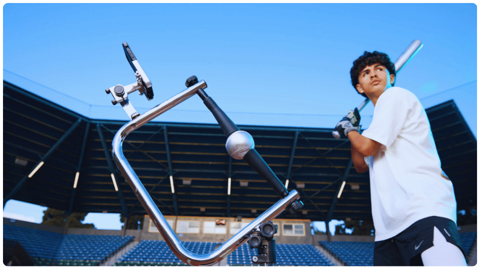 Teen baseball player preparing to swing at a ball on the Attack Tee during practice, showcasing the best baseball tee for 14-year-old players to develop consistent swing mechanics and precision hitting.