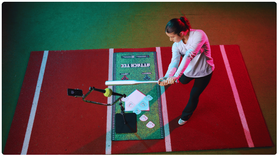 Best batting tee for kids baseball practice – young player swinging at an adjustable Attack Tee with bat path angle guides and strike zone placement mat.