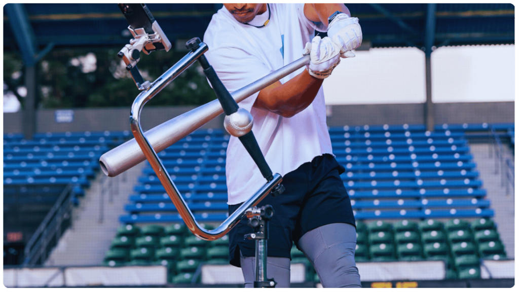 Baseball player using a tee for improving youth baseball swing, practicing precision bat-to-ball contact in a stadium setting.