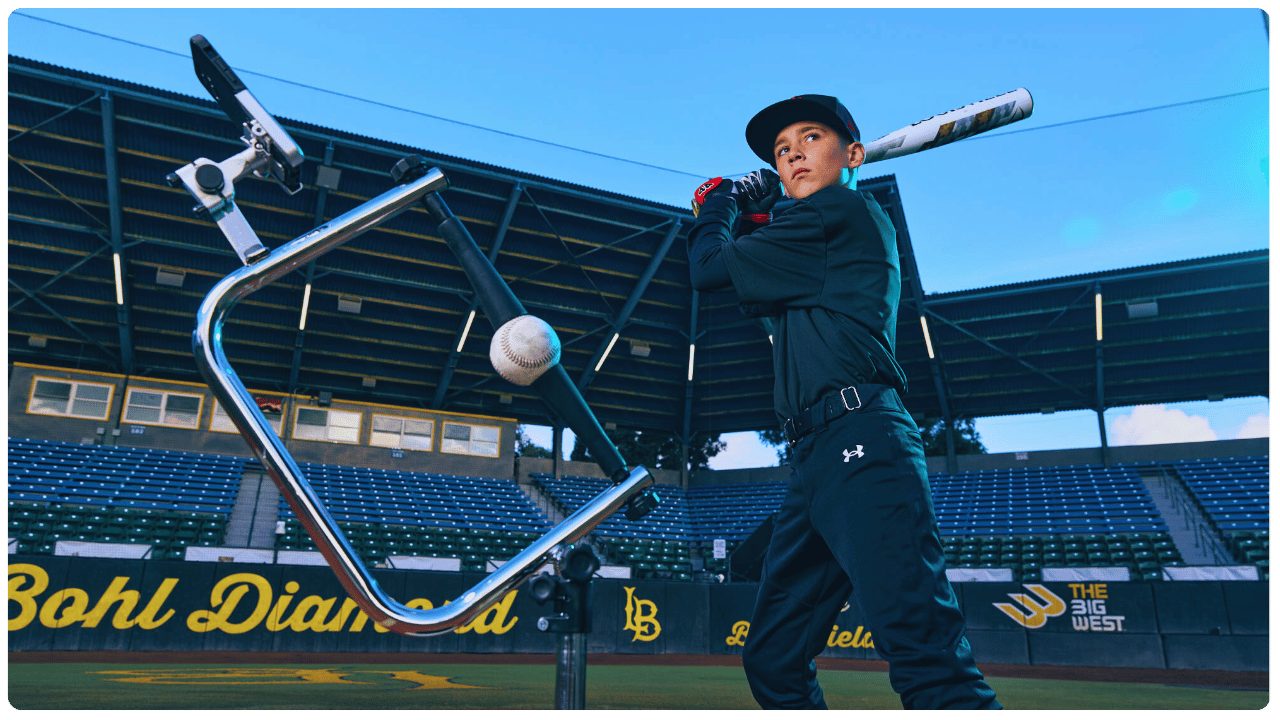 Young baseball player training on the best batting tee for young baseball players at Bohl Diamond, focusing on stance, timing, and swing mechanics.