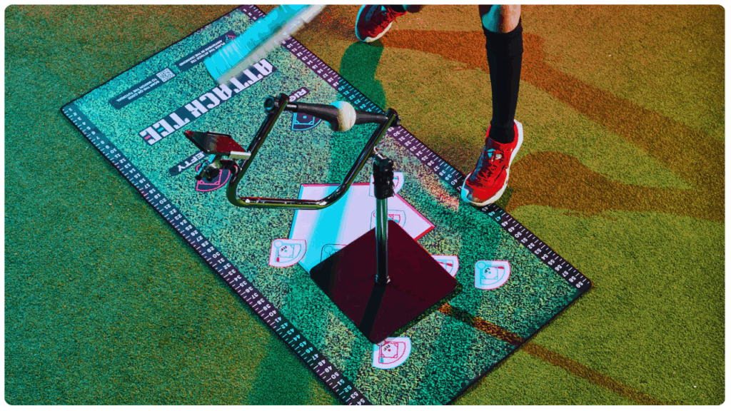 Young baseball player using the Attack Tee training tool on a marked placement mat, demonstrating proper bat path and contact point for skill development.