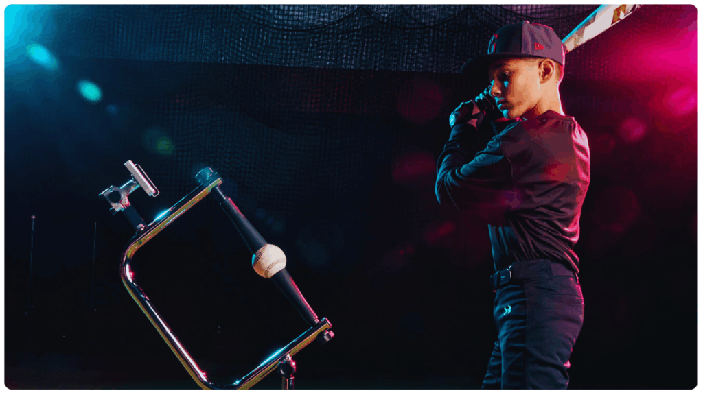 Youth baseball player preparing to swing at a ball on a new baseball batting tee with angled stem and modern training design