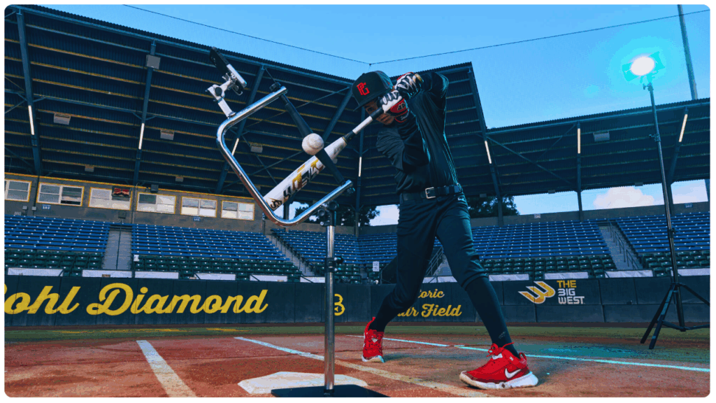 Young baseball player practicing a powerful swing using the Attack Tee—best baseball tee for 10-year-old players—on a professional field at Bohl Diamond.